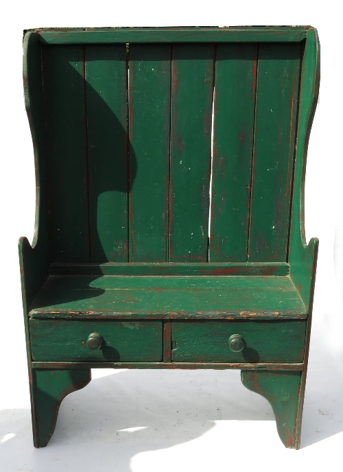 A green painted settle, fitted two drawers below, with bracket supports below, width 40.5ins