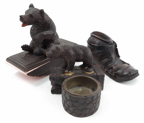 A Black Forest model, of a bear mounted on to a wooden desk blotter, together with a wooden