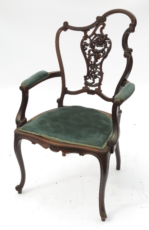 An Art Nouveau salon chair, with pierced vase back and open arms, raised on cabriole legs