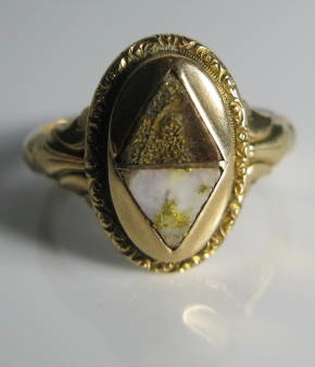 An Arizona Gold Miners Ring Set with two samples of gold rich stones