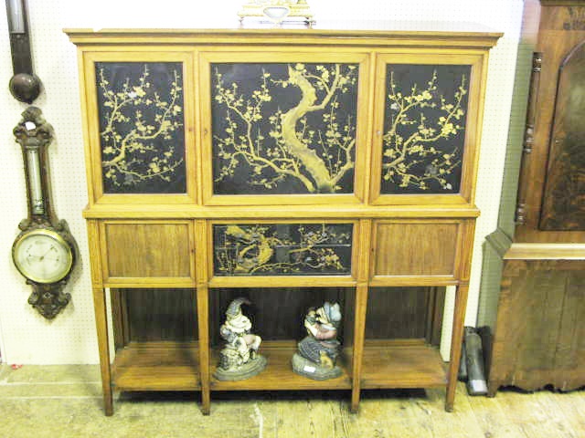 A Japanese Taste Lacquered and Prunus Decorated Cabinet the central door fitted with eight lacquered