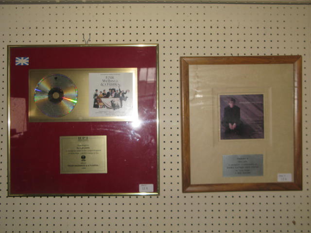 A framed CD of the music from `Four Weddings and a Funeral` presented to Elton John to recognise