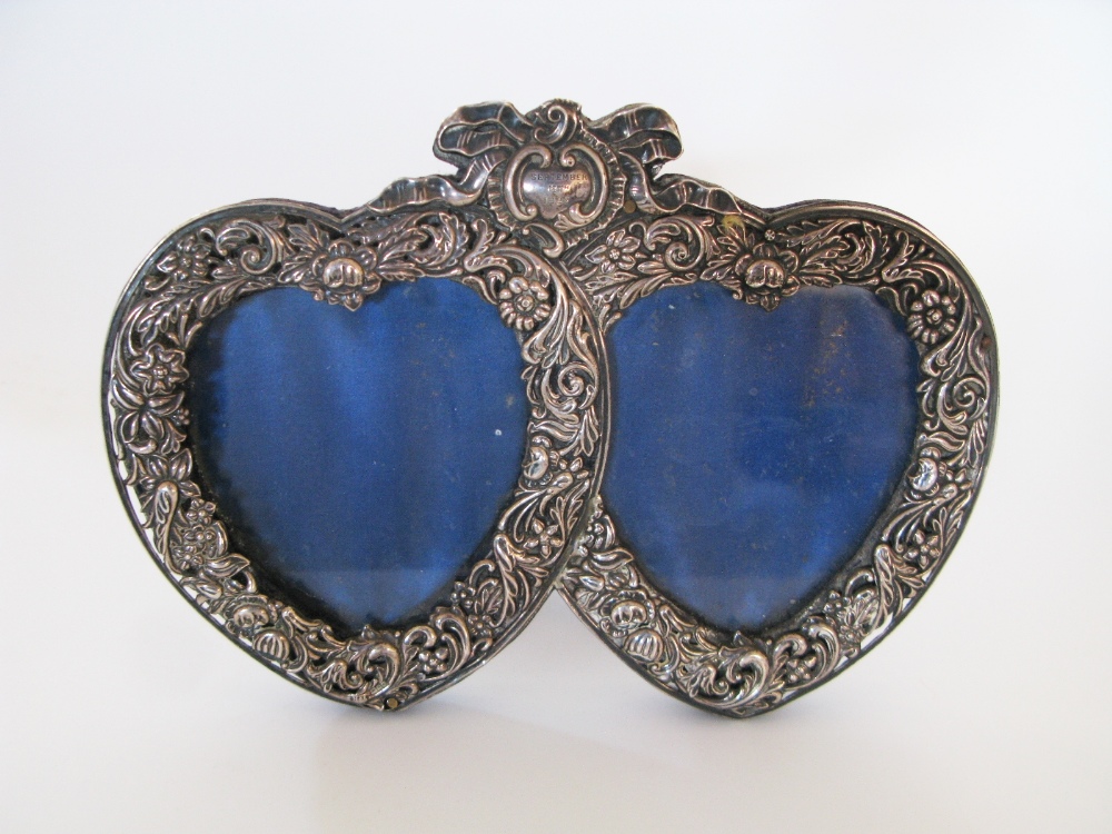 A Victorian Silver Twin Heart Shaped Photograph Frame decorated with fruiting scrolloing acanthus