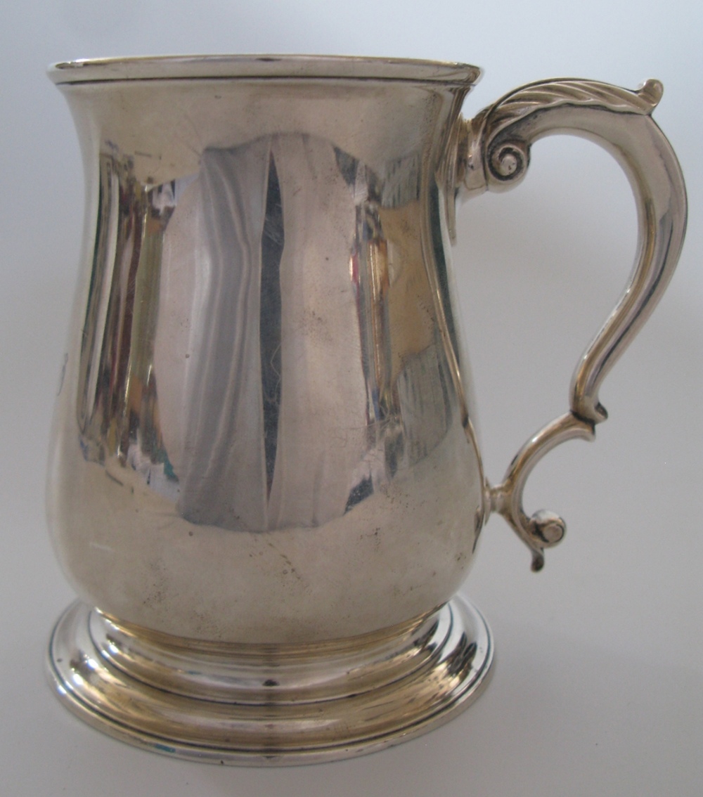 A George II Silver Beer Mug of balluster form and with leaf molded thumb piece, London 1757, John