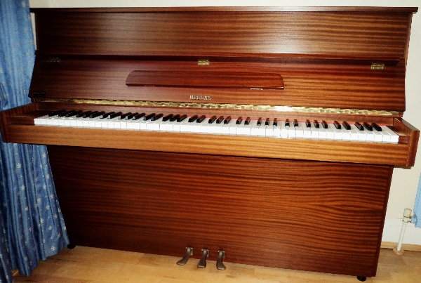 Hellas (c1981) 
An upright piano in a brown case.