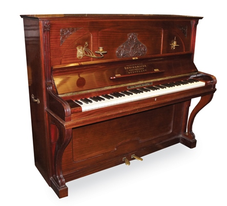 Schiedmayer 
An upright piano in an Art Nouveau style mahogany case with period sconces.