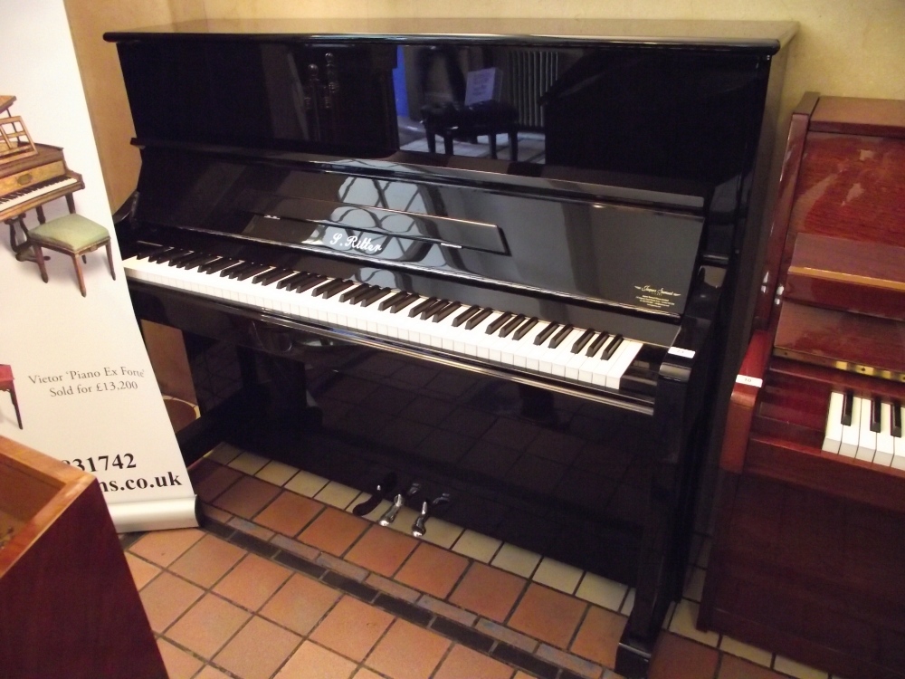 Ritter 
A 123cm upright piano in a bright ebonised case.