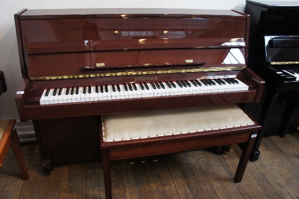 Steinbach (c2000)
A traditional upright piano in a bright mahogany case, together with a stool.
