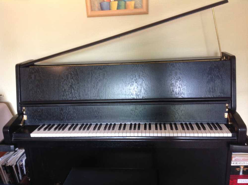 Schimmel (c1988)
A modern style upright piano in a dark satin mahogany case.  AMENDMENT New Guide