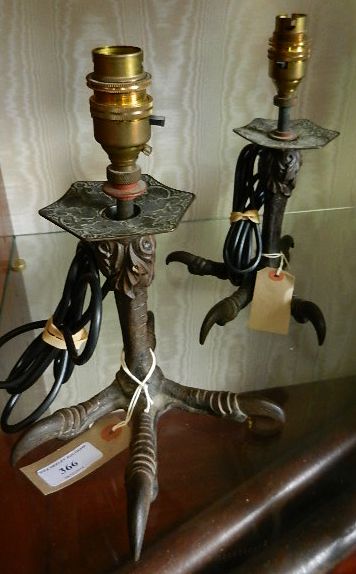 A pair of Victorian cast iron bird claw candlesticks converted to table lamps, marks to the base