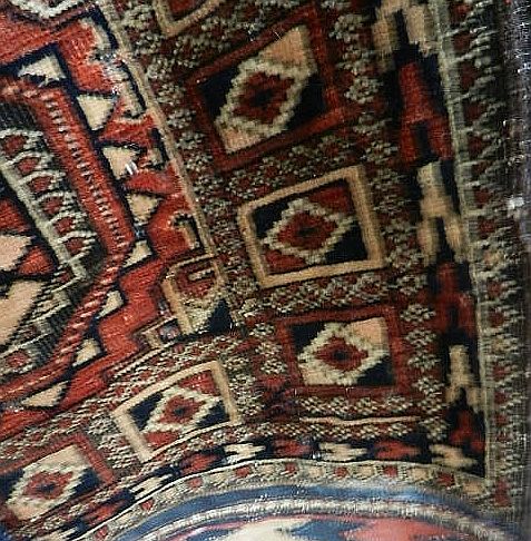A dark red Bokhana rug