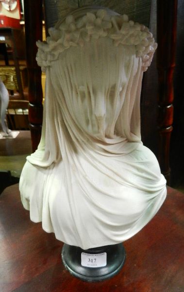 A simulated alabaster resin bust of a veiled female