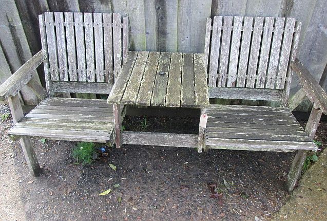 A garden two-seater bench with centre table