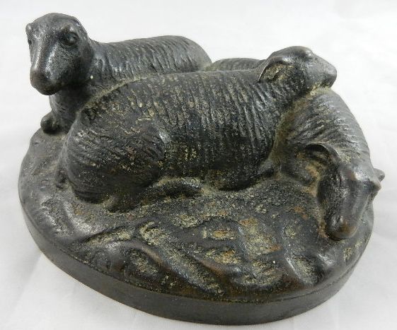 A bronzed cast iron group of sheep, with lead filled base