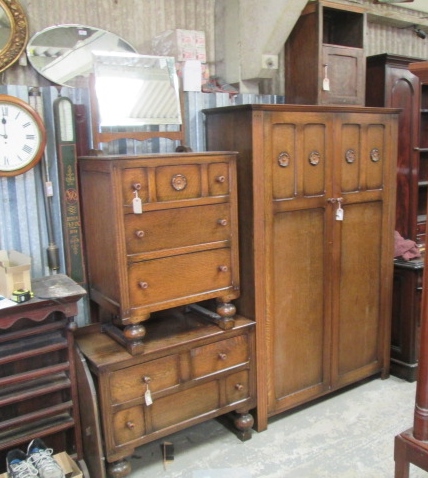 An early 1930's oak bedroom suite comprised of a double bed, pot cupboard, dressing chest, chest