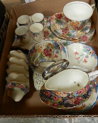 A mid 20th century Royal Winton chintz trio and cream jug, a Royal Winton chintz toast rack and milk