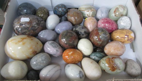 A box of assorted specimen eggs and orbs including agate, onyx and granite examples