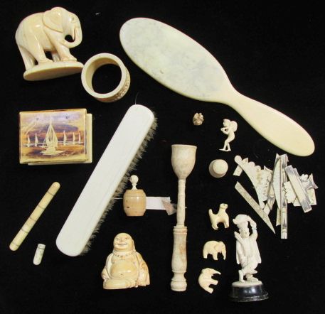 A quantity of 19th and early 20th century ivory, bone, and carved nut items including a tape
