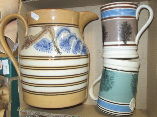 A large Victorian mocha ware jug and two tankards (3 items)