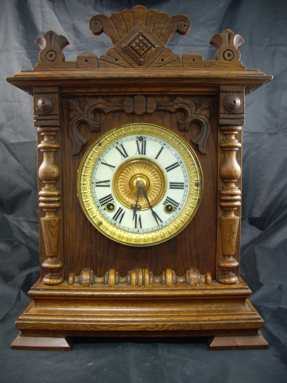 An early 20th century eight day Seneca strike oak cased bracket clock, the enamel dial with Roman