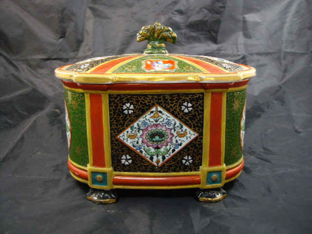 A 19th century Ashworth's ceramic Oriental-style biscuit box of oval form, decorated with figural