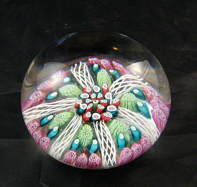 A Whitefriars domed crystal paperweight with pink, green, red, blue and lattachino canes, 7.5cm dia