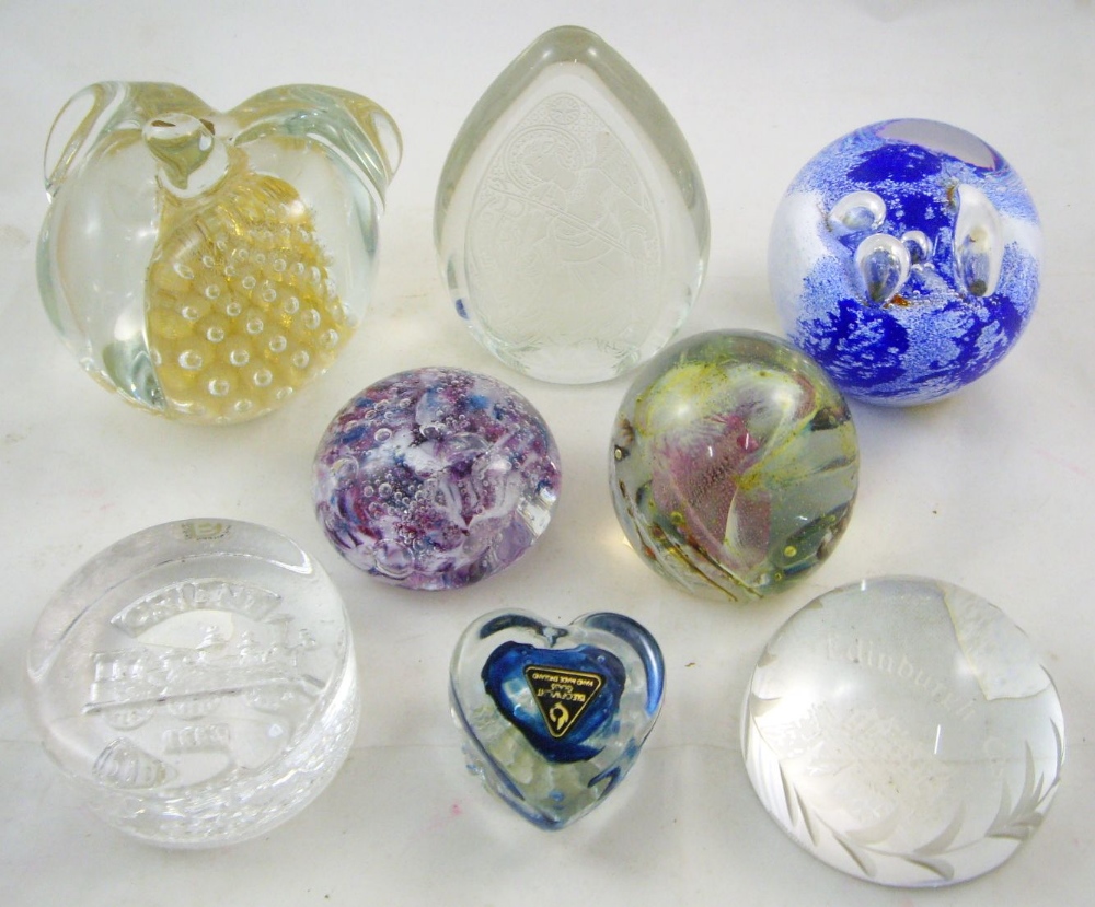 A collection of eight art glass paperweights to include a Swedish F.M. Konstglas example in the form