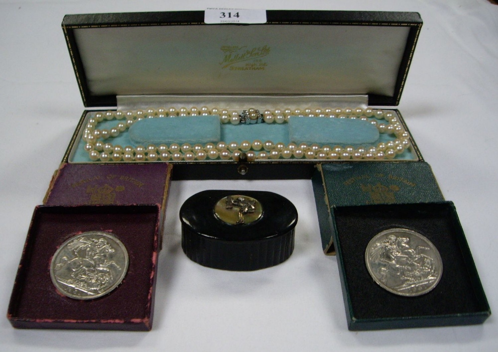 A string of cultured pearls with silver clasp, a papier mache snuff box, and two Festival of Britain