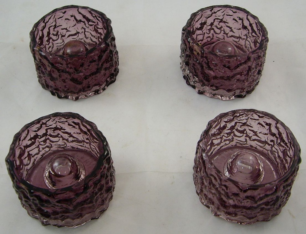 Four Whitefriars amethyst glass 'Bark' candle holders from the textured range, of cylindrical