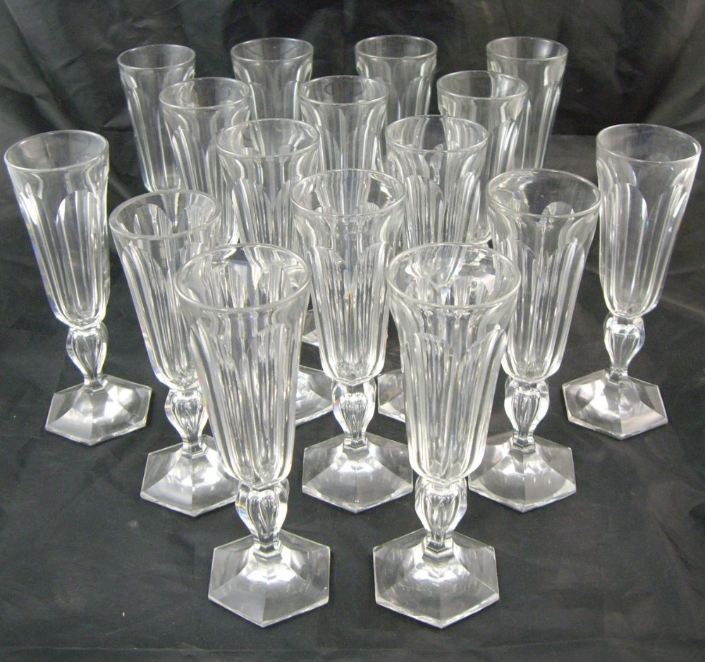 A set of 16 19th century panel cut glass champagne flutes (one ground down)