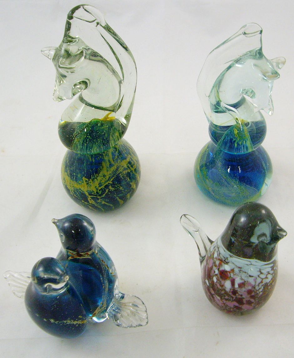 Four Mdina glass paperweights to include two graduated sea horses, a pair of lovebirds and a short