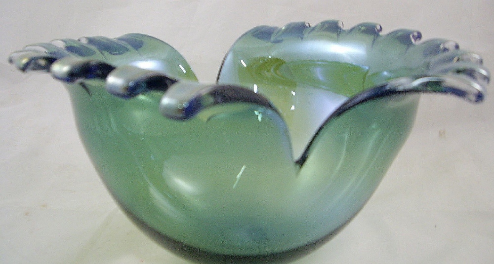 A 20th century cut glass bowl of oval form with split tooth rim and green and blue iridescent