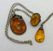 An amber and silver ring, a similar pendant and another (3)