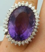 A fine and large amethyst and diamond cluster ring, size Q (one stone missing), centre stone