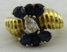Ornate ring set with pear cut diamond and sapphires size, K