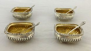 Set of four silver and gilt table salts in fitted box with original spoons, Jay`s of London