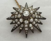 Antique diamond and rose gold star brooch