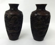 A pair of Chinese well carved heavy cinnabar vases decorated with dragons, 24cm tall (2)