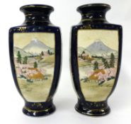 Pair of Japanese Satsuma vases, Meiji period, with 4 decorated panels on dark blue ground, marks to