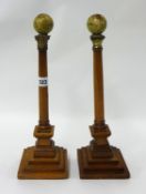 Pair wood candlesticks surmounted with miniature globes