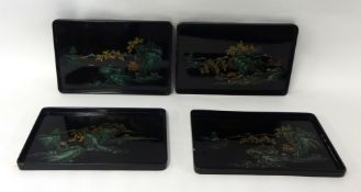 Four Oriental lacquered serving trays
