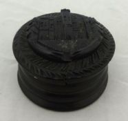 Carved circular wood snuff box with raised castle design