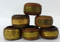 Set of six wood napkin rings with plaques each made from various timbers of great ships