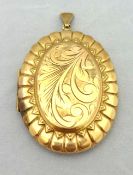 A large 9ct rose gold locket with embossed design, approximately 20.50g
