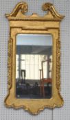 A 19th century gilt framed wall mirror with swan neck decoration, 117cm x 65cm
