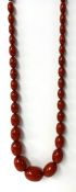 Red amber necklace, 116cm long, graduated, approx 128g