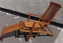 An oiled teak steamer chair and loose cushion