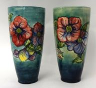 A pair of tall W.Moorcroft vases signed in green, one with original paper label, of taper design,