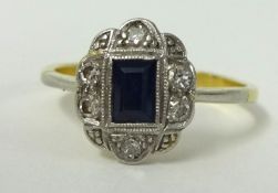 An Art Deco style ring set with diamonds and sapphire, size N