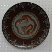 A Japanese Cloisonne plate decorated with a dragon, 36cm diameter